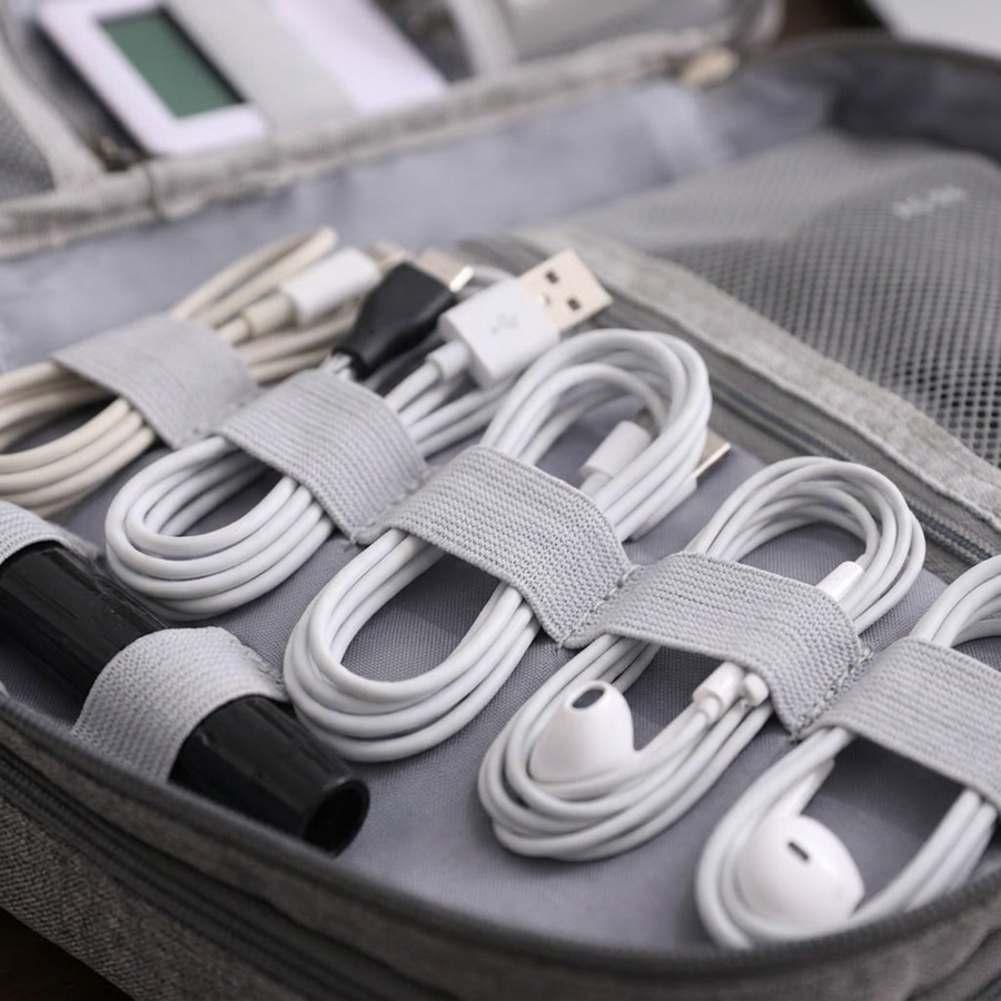 Close-up of charging cables held in the lid's elastic loops