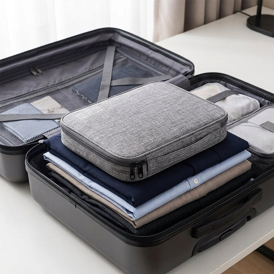 Cable organiser bag lying flat in a packed carry-on